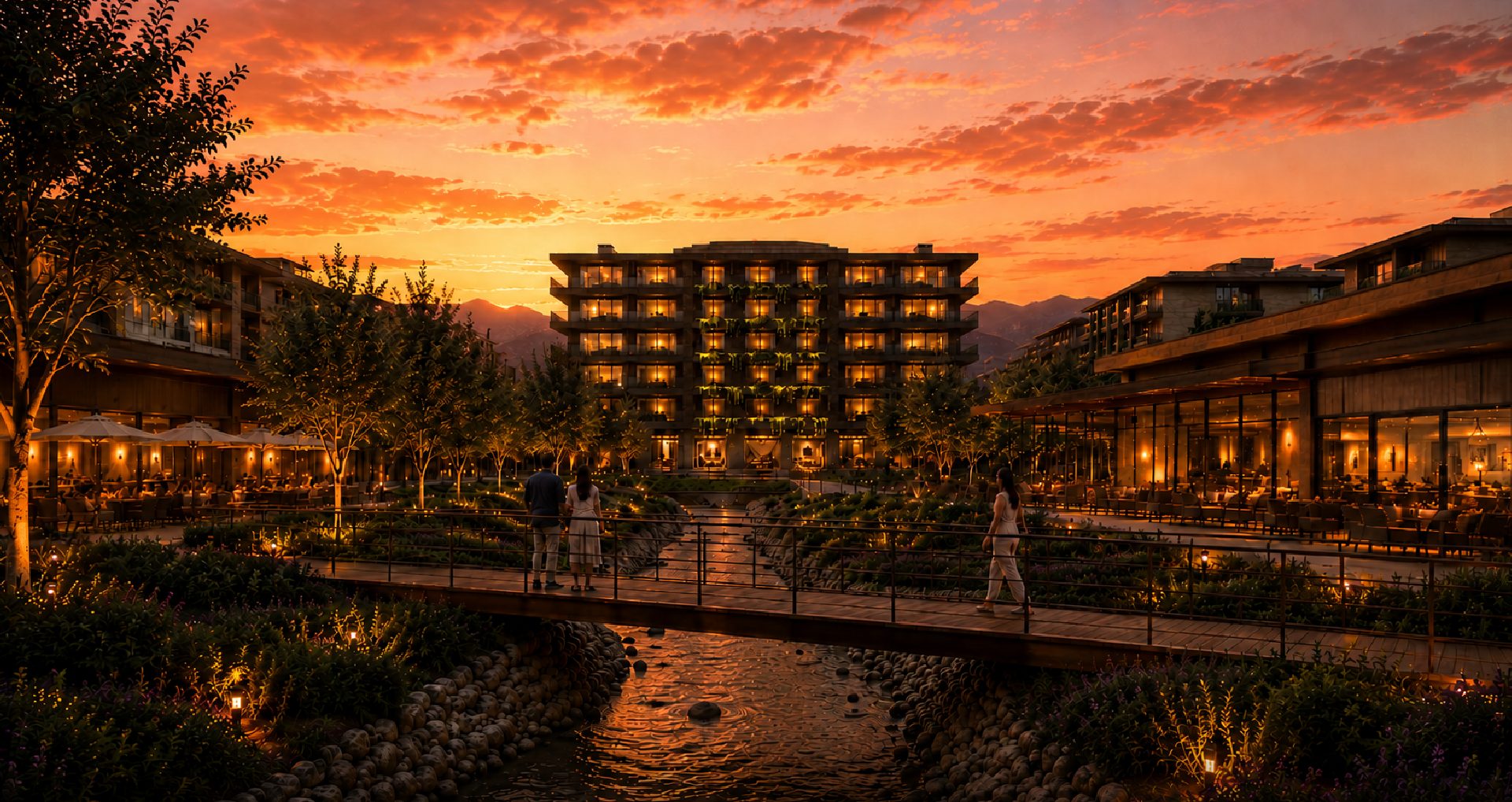El cauce con su puente y el hotel al atardecer